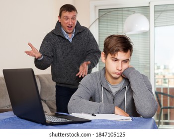 Father Scolds His Son For Bad Schooling. High Quality Photo