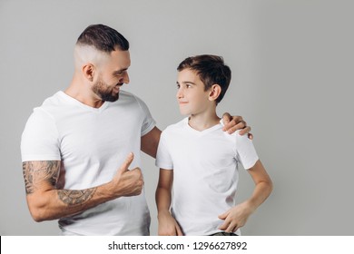 Father Shows Thumbs Up To His Kid, Isolated On Grey Background. Daddy Cheers His Son Up. Well Done. Atta Boy, Goo Of You, Excellent. Man Is Proud Of His Little Brother.