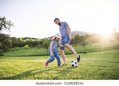 Father with a small daughter playing with a ball in spring nature. - Powered by Shutterstock