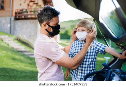 Father With Small Son Going On Trip By Car, Wearing Face Masks.