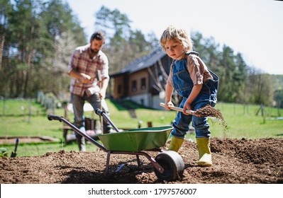 Father with small son working outdoors in garden, sustainable lifestyle concept. - Powered by Shutterstock