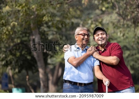 Father and son admiring nature at park
