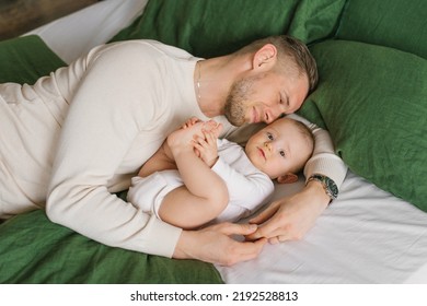 Father And Son Baby Lying On The Bed And Enjoying The Moment