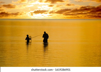 A father and son bond together while fishing in the Outer Banks North Carolina - Powered by Shutterstock