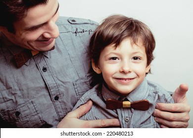 Father With Son In Bowties On White Background, Casual Look Family