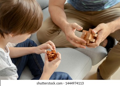 Father And Son With Brain Teaser Toys At Home