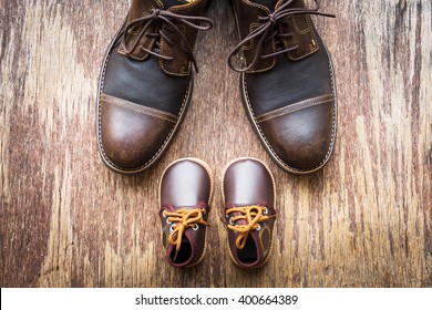 Father and son brown shoes on wooden background, fathers day  - Shutterstock ID 400664389
