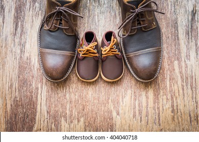 Father and son brown shoes on wooden background, fathers day  - Powered by Shutterstock