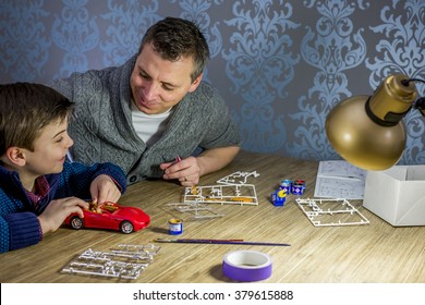 Father And Son Building A Model Car