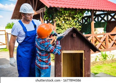 Father And Son Building Tree House Together.