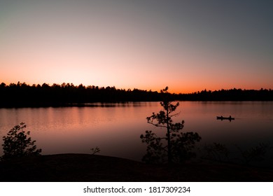 Father Son Canoeing At Sunset In The Boundary Waters Canoe Area Wilderness