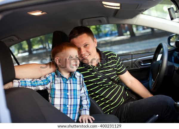 Father and son in the\
car.