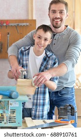 father and son in carpentry workshop