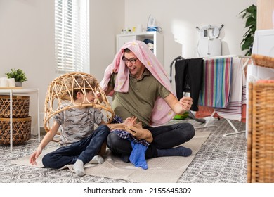 Father And Son Cleaning In Bathroom, Laundry Room, Throwing Clothes Out Of Wicker Basket, Packing Things Into Washing Machine, Man Playing With Child.