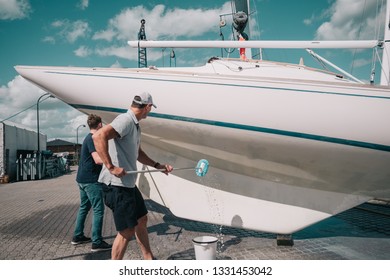 Father And Son Cleaning A Boat