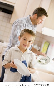 Father And Son Cleaning Dishes