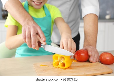 Father and son cooking together, closeup - Shutterstock ID 623077514