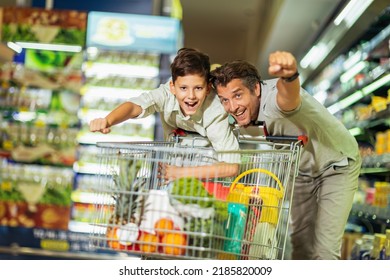 Father and son doing grocery shopping at the supermarket - Shutterstock ID 2185820009