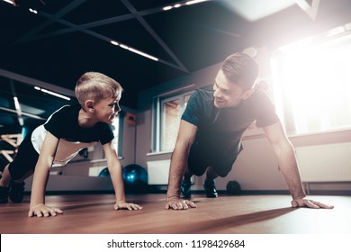 Father And Son Are Doing Push Ups In The Gym. Parenthood Relationship. Sporty Family Concept. Active Lifestyle. Triceps Exercise. Holiday Leisure. Working Out Together. Fitness Day.