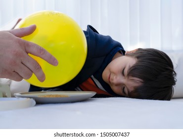 Father And Son Doing Science Project, Experiment With Gelatine And Static Charged Balloon,Man Holding Balloon Above Plate Of Dry Gelatin Crystals,boy Child Looking Curiously At Science Experiment.