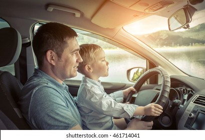 Father And Son Driving In Car