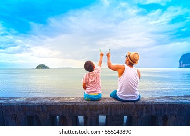 Father and son   eat ice cream Or Family Asian holding ice cream on the beach.
 - Powered by Shutterstock