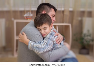 Father, Son In Emotional Embrace Of Tears And Joy