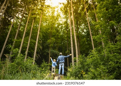 Father son enjoying nature outdoors forest adventure  - Powered by Shutterstock