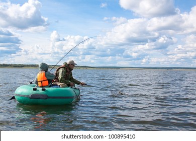 Father And Son Fishing At Boat