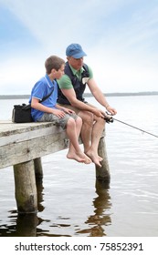 Father And Son Fishing In Lake