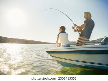 Father and son fishing on boat - Powered by Shutterstock