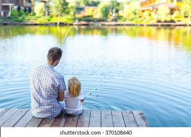 Father And Son Fishing On The Pier