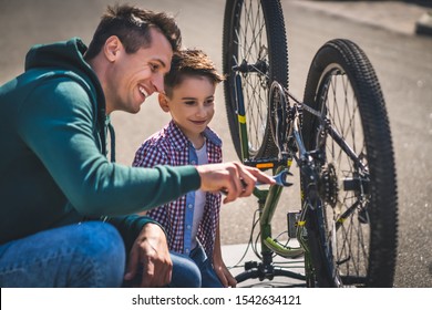 The father and son fixing the bicycle  - Powered by Shutterstock