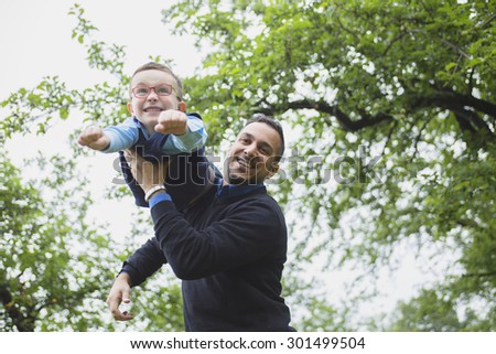 A Father and son in forest on a meadow