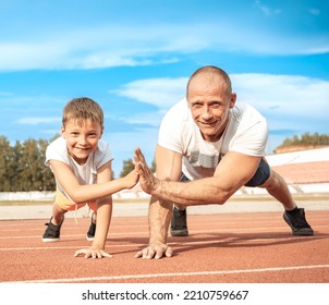 Father And Son Go In For Sports Together At Stadium. Selective Focus