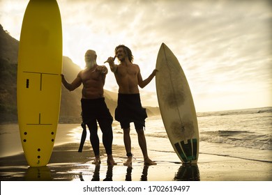 Father And Son Going To Surf On The Beach. Different Generation Having Fun Doing Extreme Sport. Holiday And Sport Concept - Image