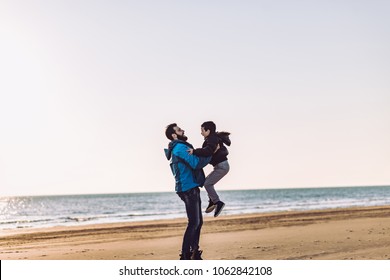 Father and son have fun on beach on sunny day - Shutterstock ID 1062842108