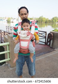 A Father And Son Have A Happy Trip On Vacation By A Baby Carrier Hip Seat.