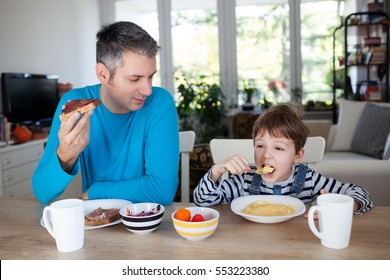 Father and son having breakfast at home