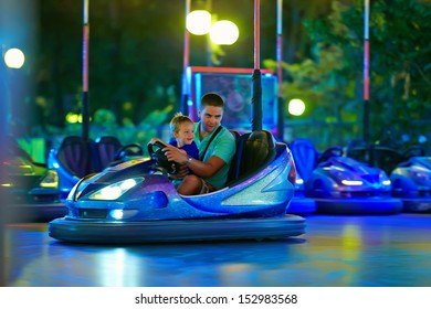 Father And Son Having Fun, Driving Electric Toy Car