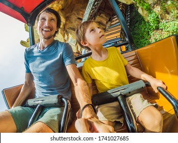 Father And Son Having Fun On Rollercoaster