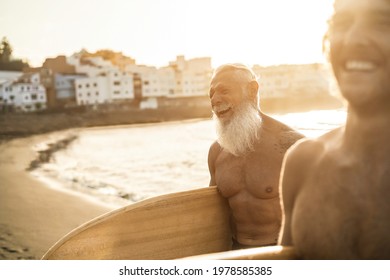 Father And Son Having Fun On The Beach After Surf Session - Focus On Senior Man Face