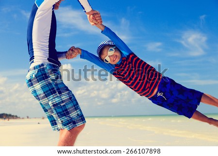 Similar – Image, Stock Photo Father and son playing superhero on the beach at the day time. People having fun outdoors. Concept of summer vacation and friendly family.