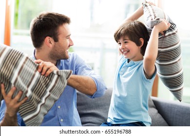 Father And Son Having Pillow Fight
