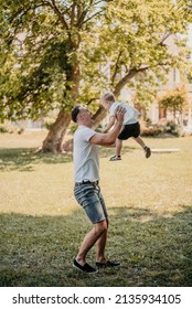 Father And Son Having A Play Date In The Park. They Are Celebrating International Father’s Day.