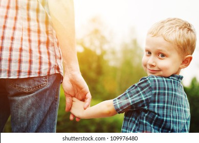 Father And Son Holding Hand In Hand