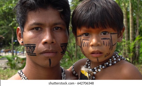 Father And Son At An Indigenous Tribe In The Amazon