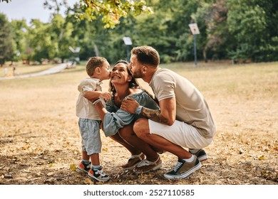 Father and son kissing mother in nature and having fun.  - Powered by Shutterstock