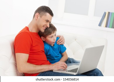 Father and son. Father and son looking at computer monitor and smiling