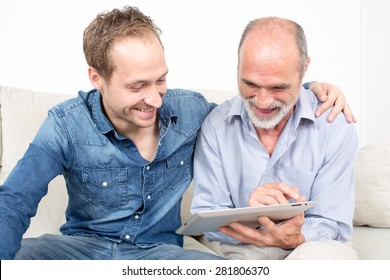 Father and son looking at ipad device